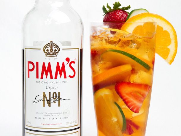 Pimm's Cup cocktail next to bottle of Pimm's.