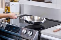 The All-Clad Stainless steel skillet is placed on an induction cooktop