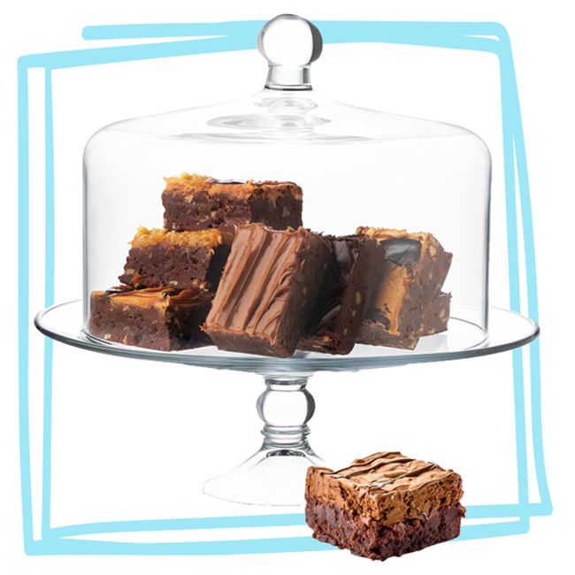 Glass cake stand with dome lid holding brownies