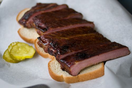 Saint Louis style ribs on two slices of bread with pickles 