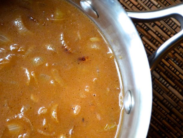 close up view of brown onion gravy in saucepan
