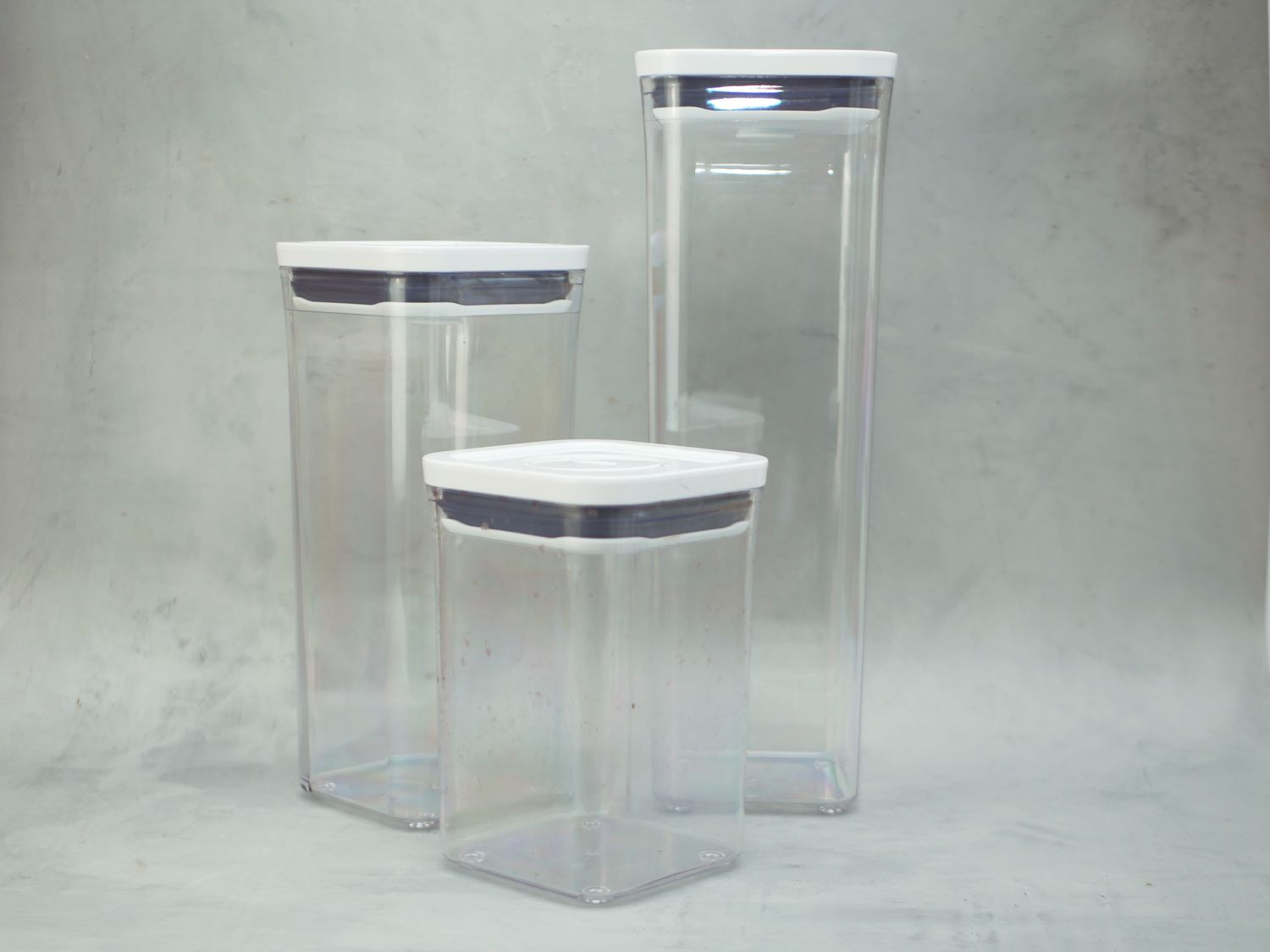 three oxo food containers on a gray backdrop
