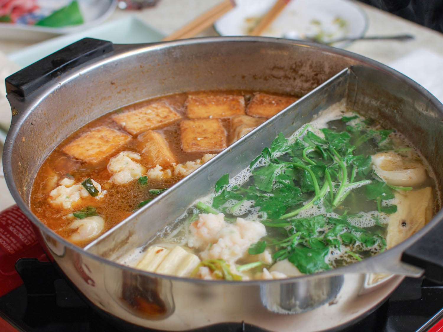 Chinese hot pot filled with two different broths.