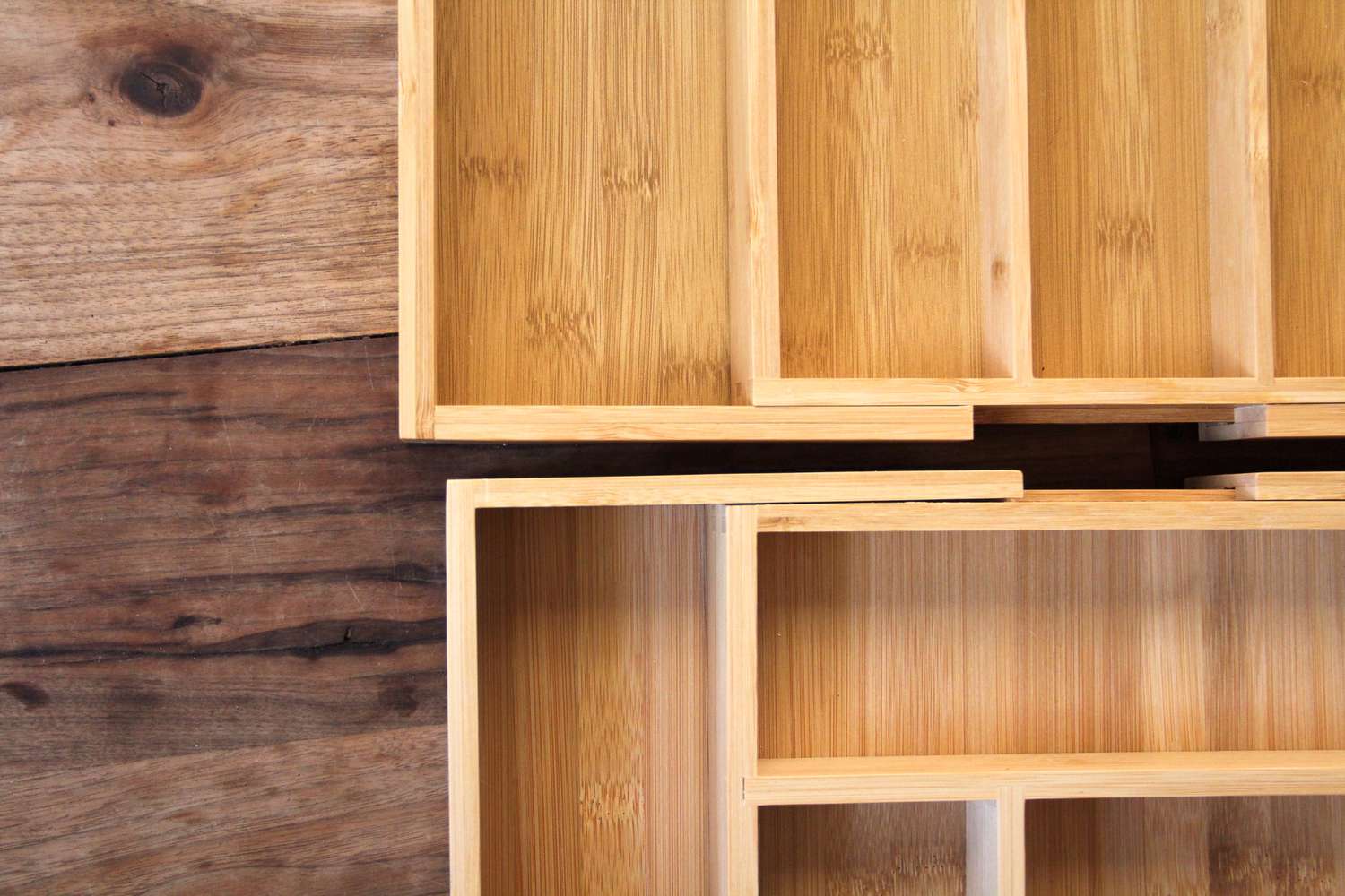 Two adjustable wooden kitchen drawer organizers.