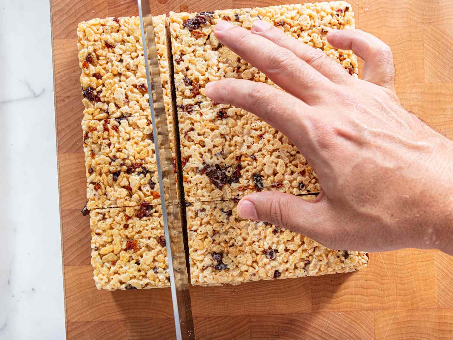 cutting cooked rice krispies into squares