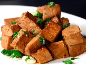 A plate of frozen tofu braised in soy sauce. 