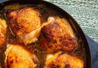 Cooked chicken thighs in a pan