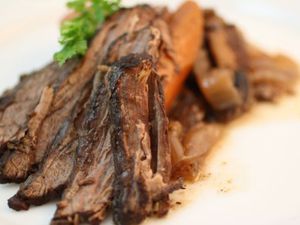 Sliced brisket on a white plate.