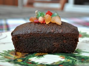 Profile view of an individual spiced fruitcake, topped with extra candied fruit mix.