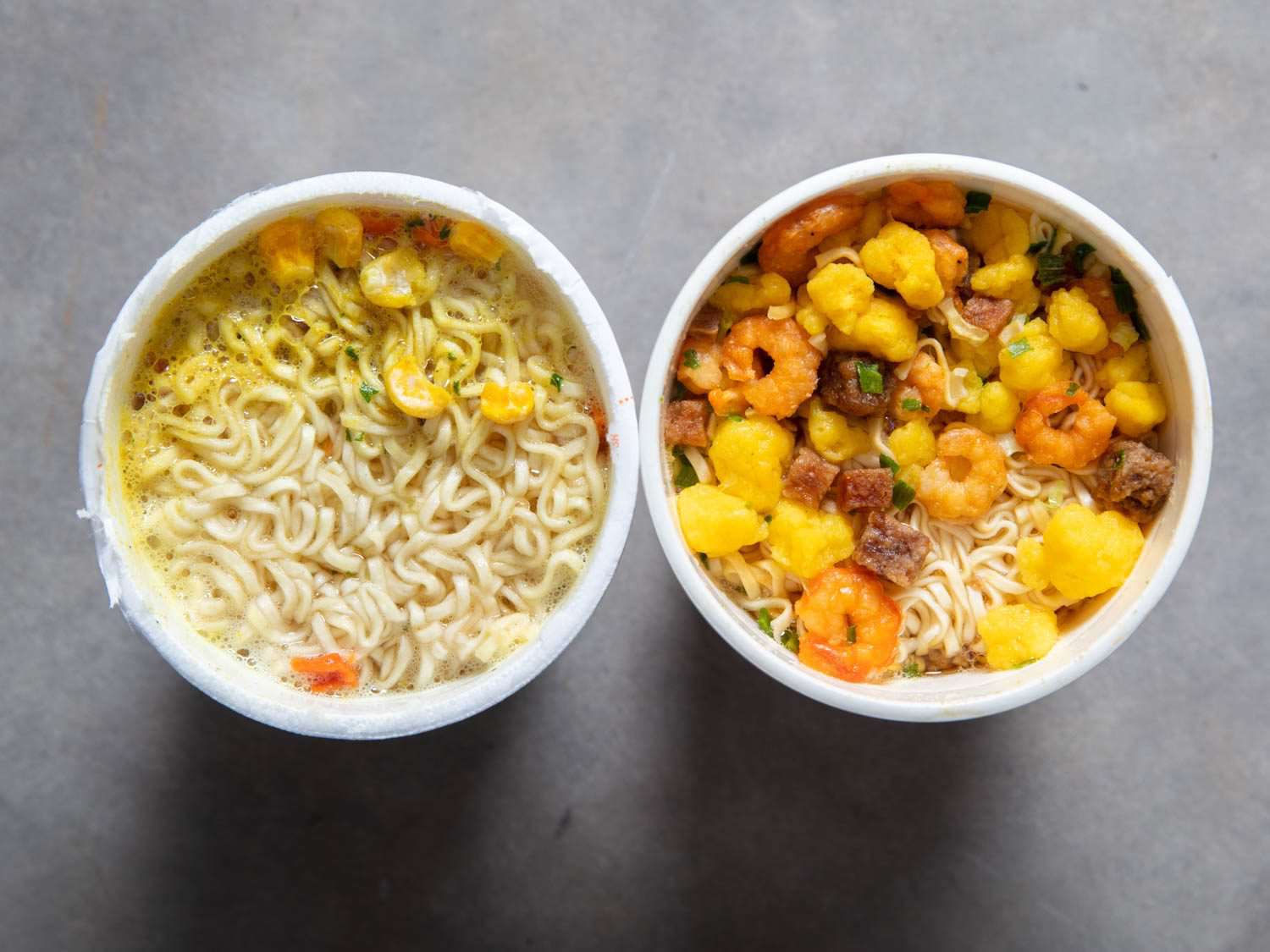 Overhead comparison shot of American Chicken Cup Noodles cup and Japanese Chicken Cup Noodle.
