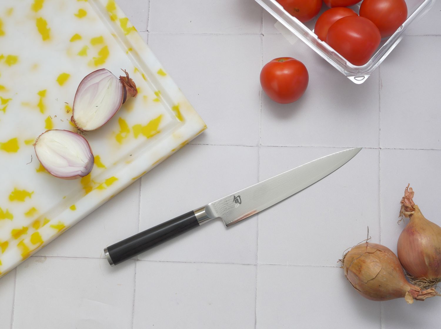 a knife on a white tile surface