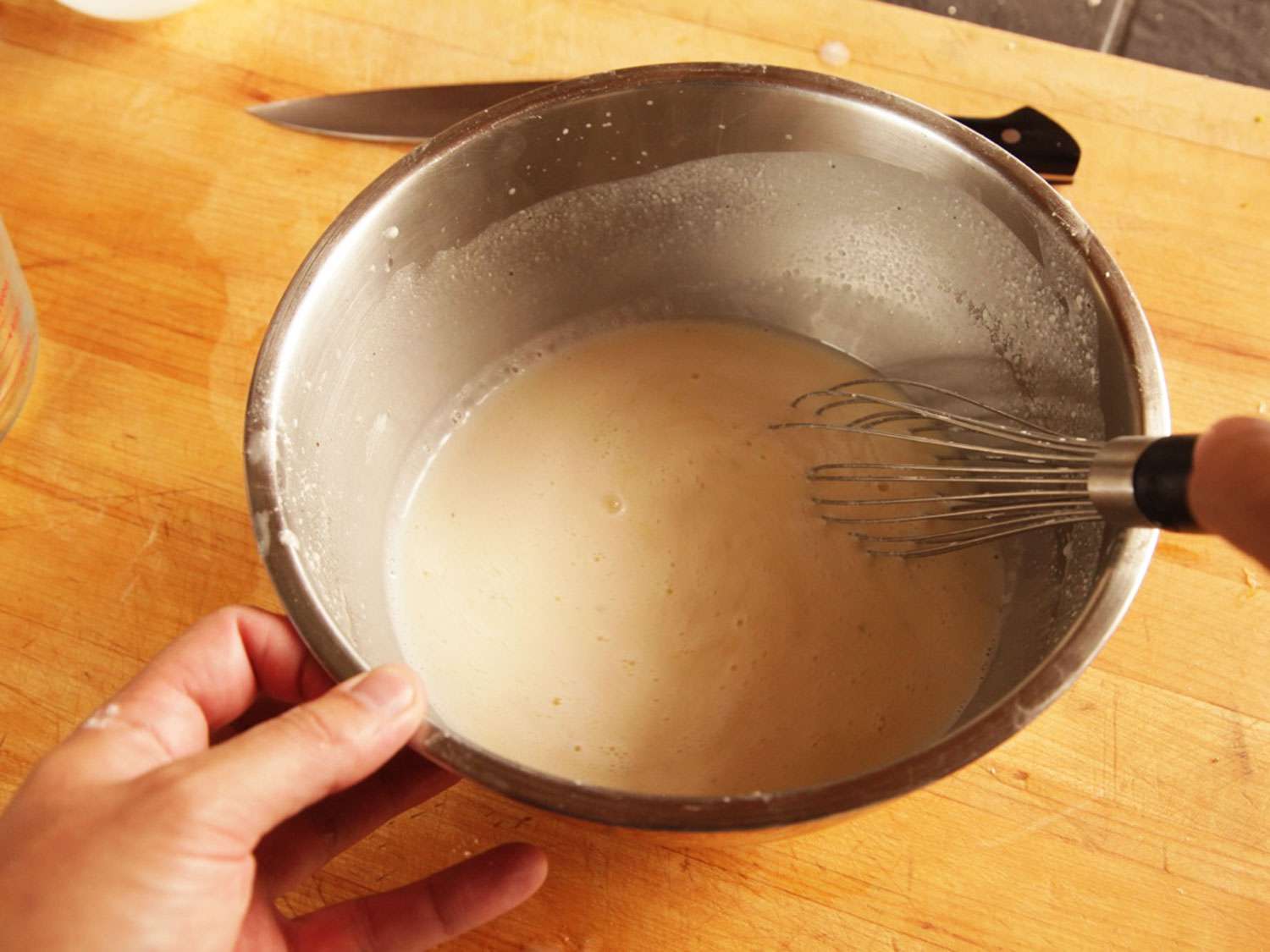 Whisking lightened alfredo sauce.