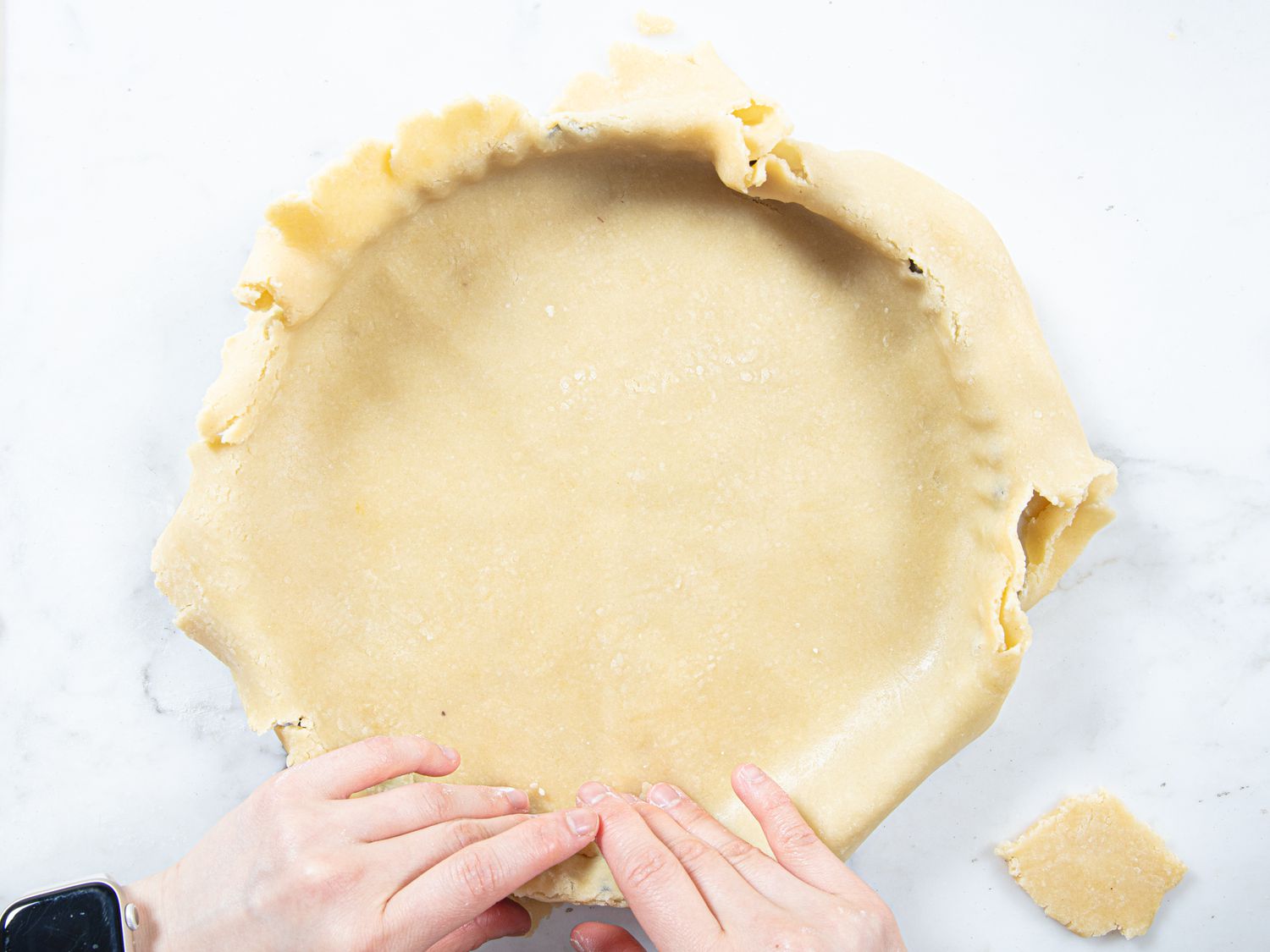 Overhead view of dough flipped onto pan
