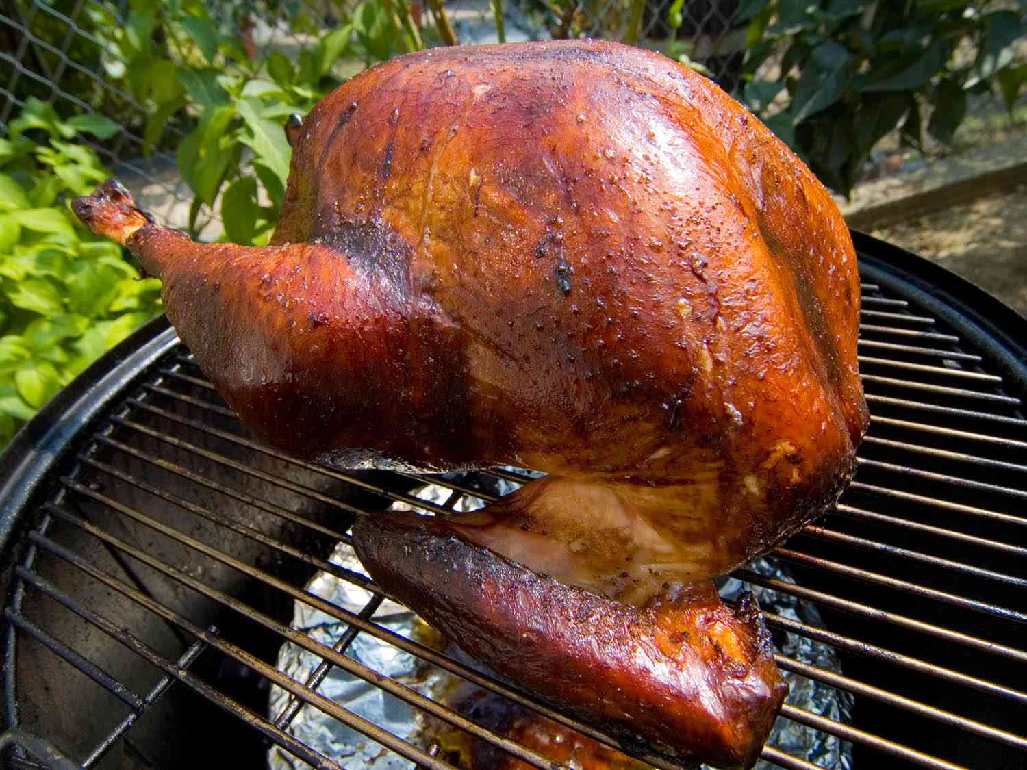 A smoked turkey on a Weber grill.