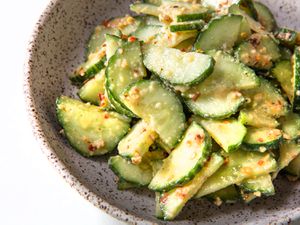 A bowl of cucumber salad tossed in mustard-oil dressing