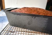 A side view of bread baked in the Lodge Seasoned Cast Iron Loaf Pan