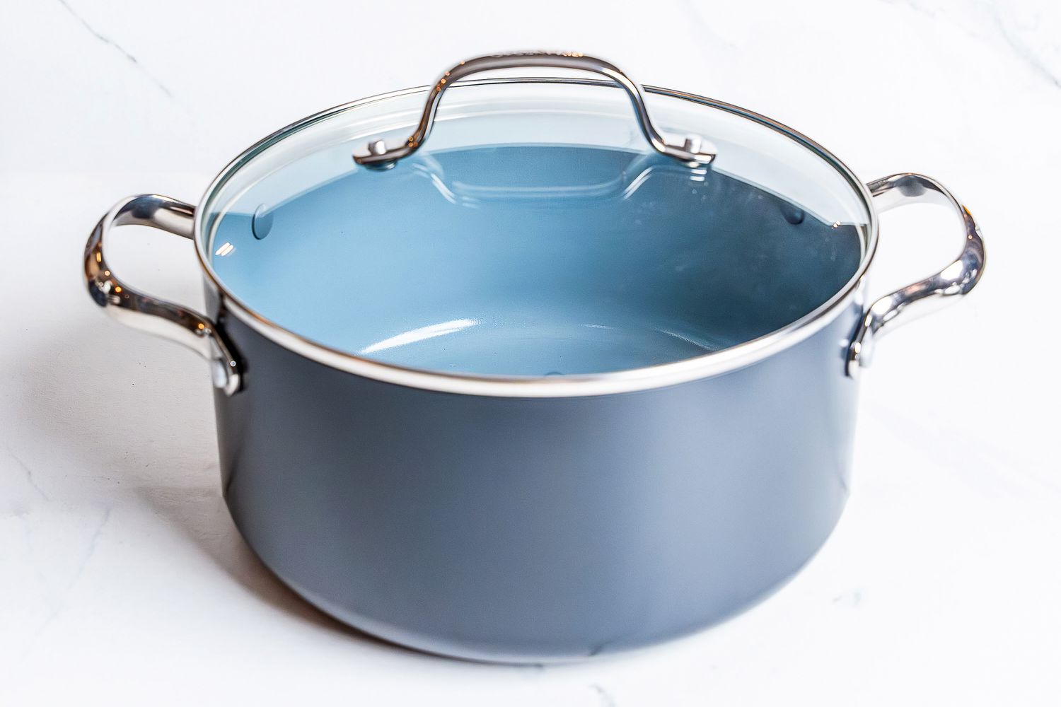 A pot from the GreenPan Valencia Pro Ceramic Nonstick 11-Piece Cookware Set on a white surface