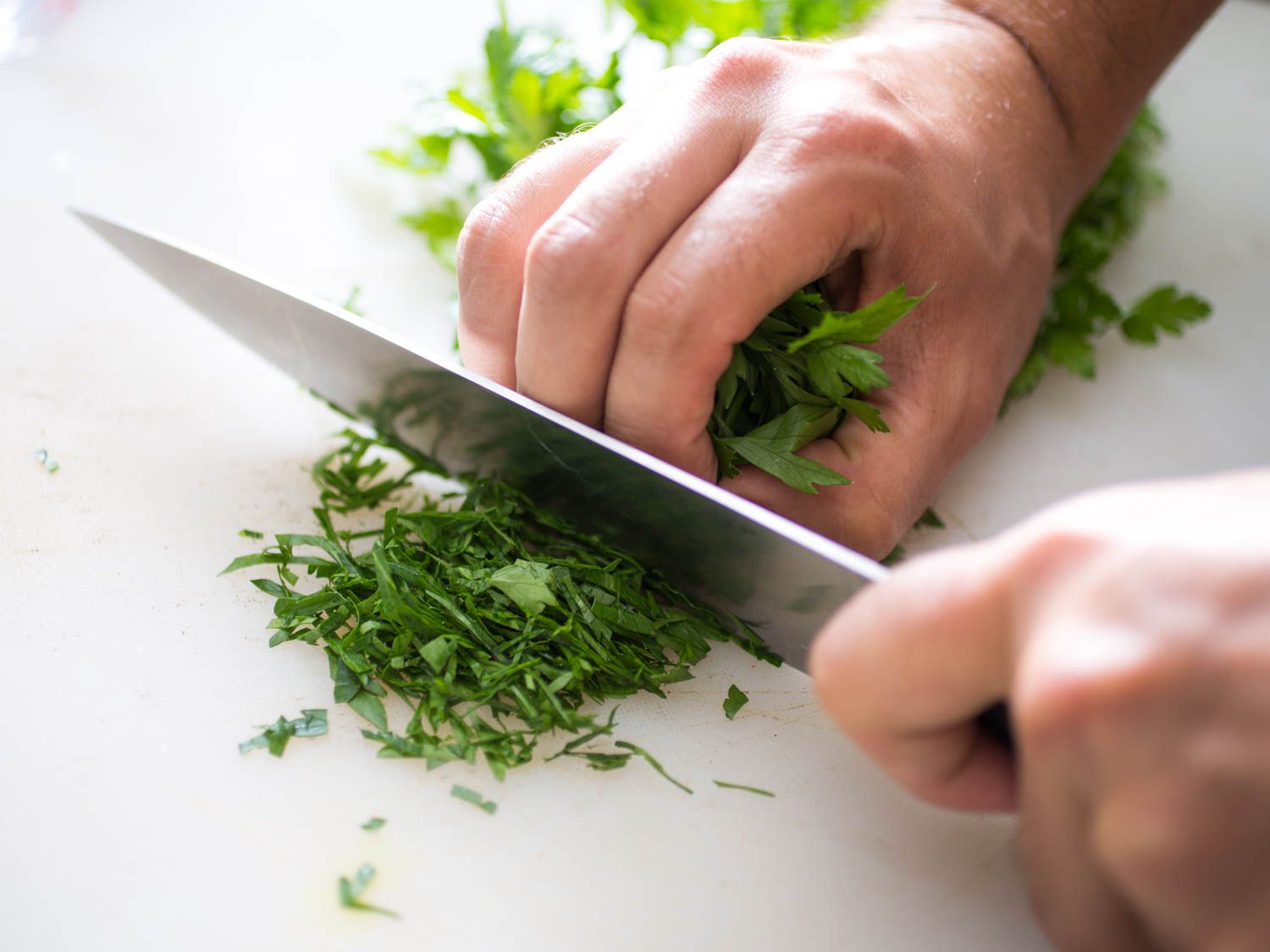 Finely chopping parsley for tabbouleh.