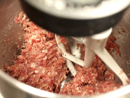 Sausage being kneaded with paddle attachment in stand mixer