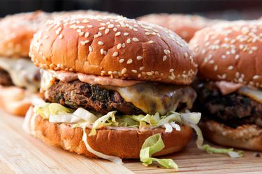 Black bean burgers on a bamboo cutting board. 