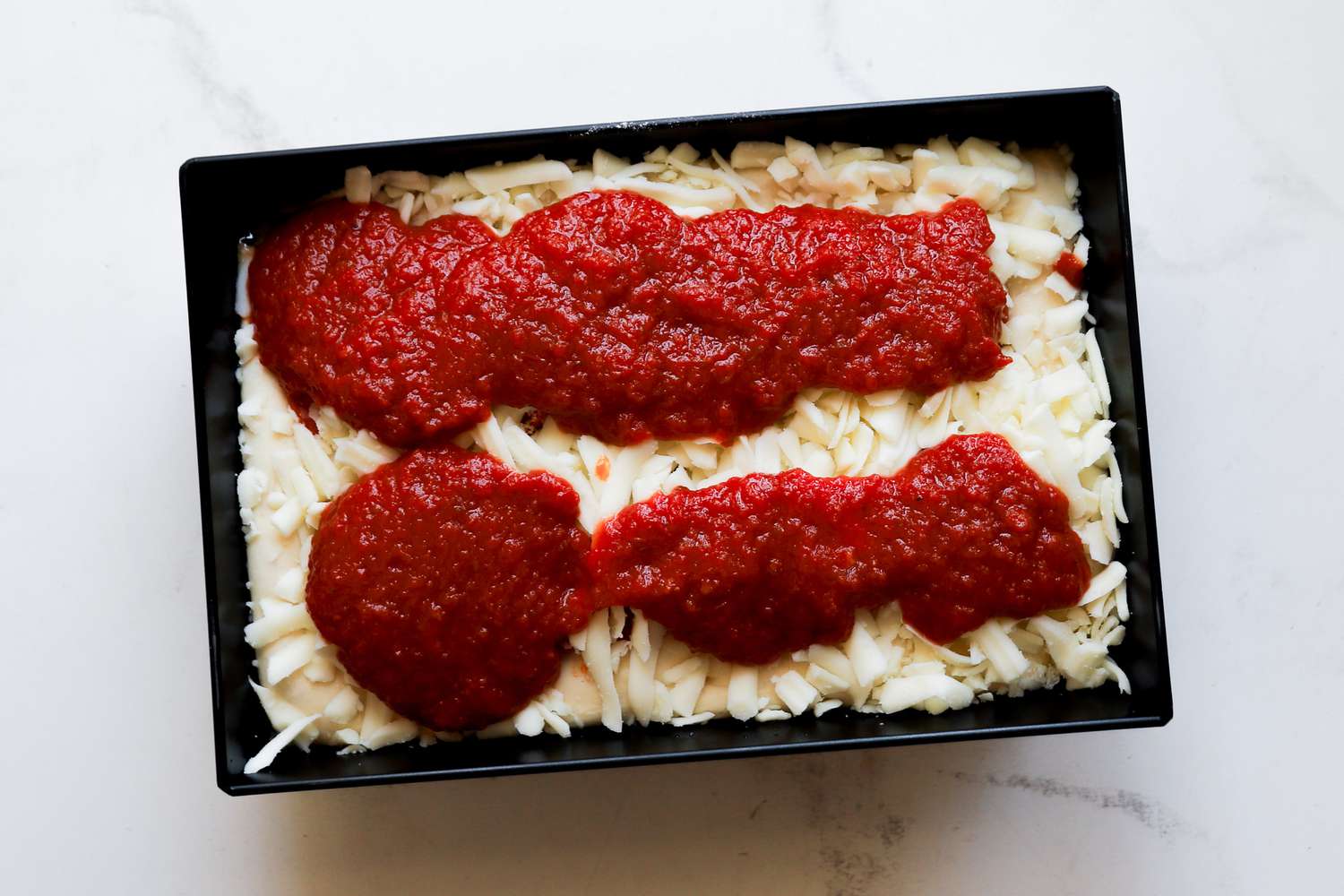 A pizza being assembled