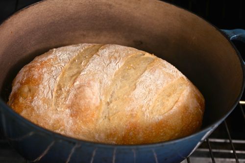 a loaf of bread baking in a Dutch oven