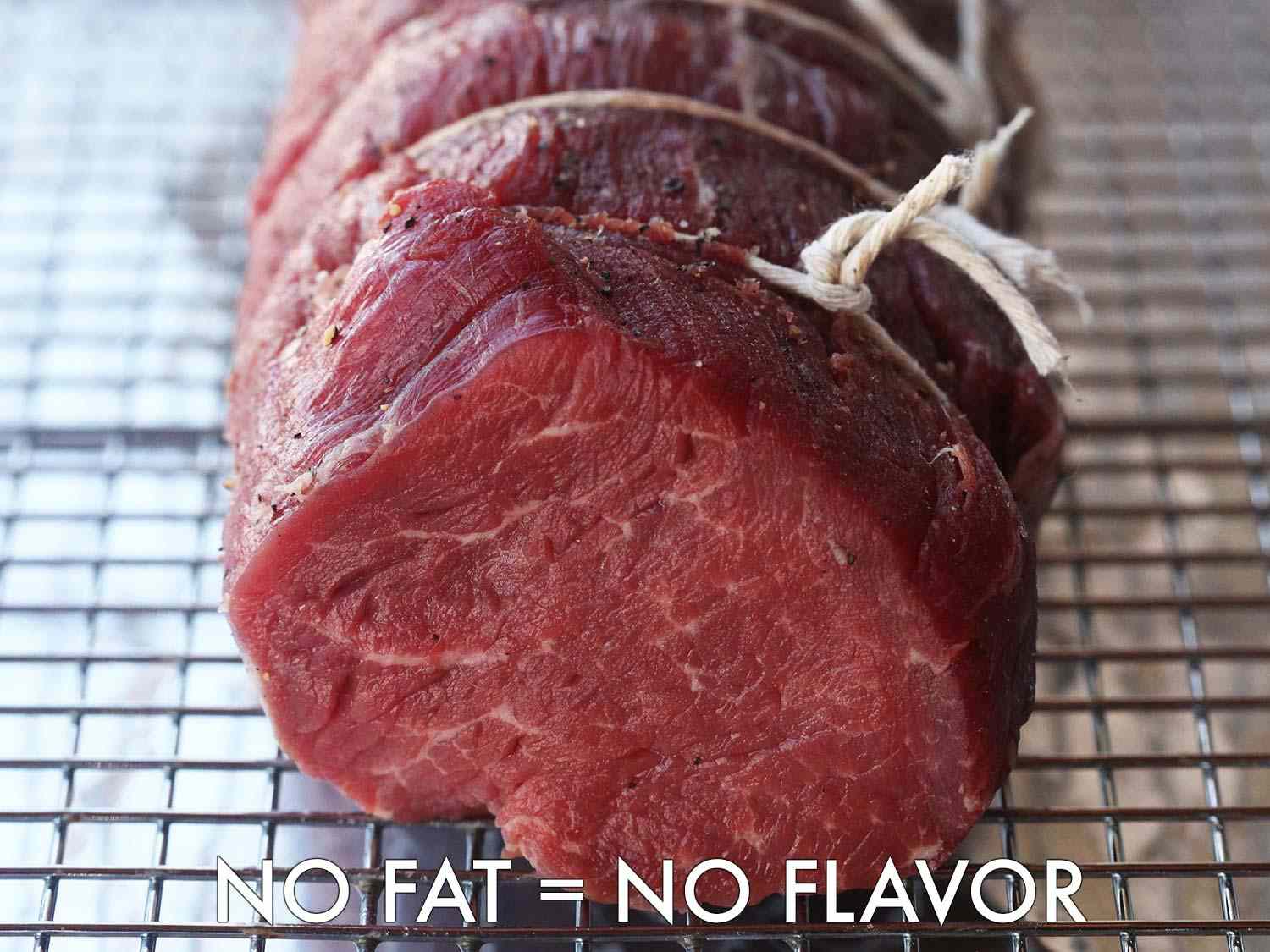 The end of a tied and seasoned raw beef tenderloin roast