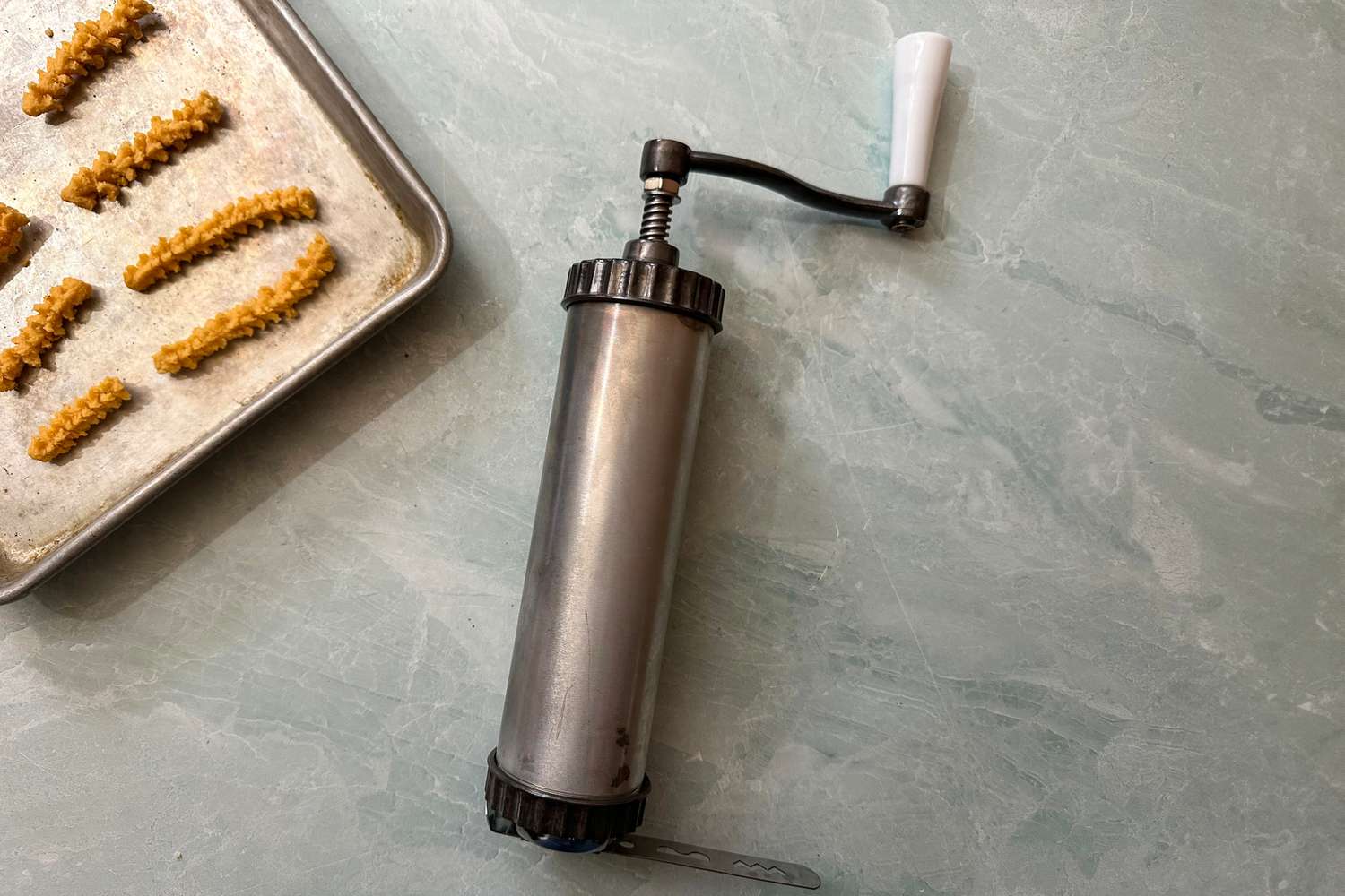The Fante’s Easy Cookie Press next to a tray of cheese straws