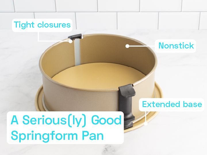 A gold springform pan on a marble countertop.