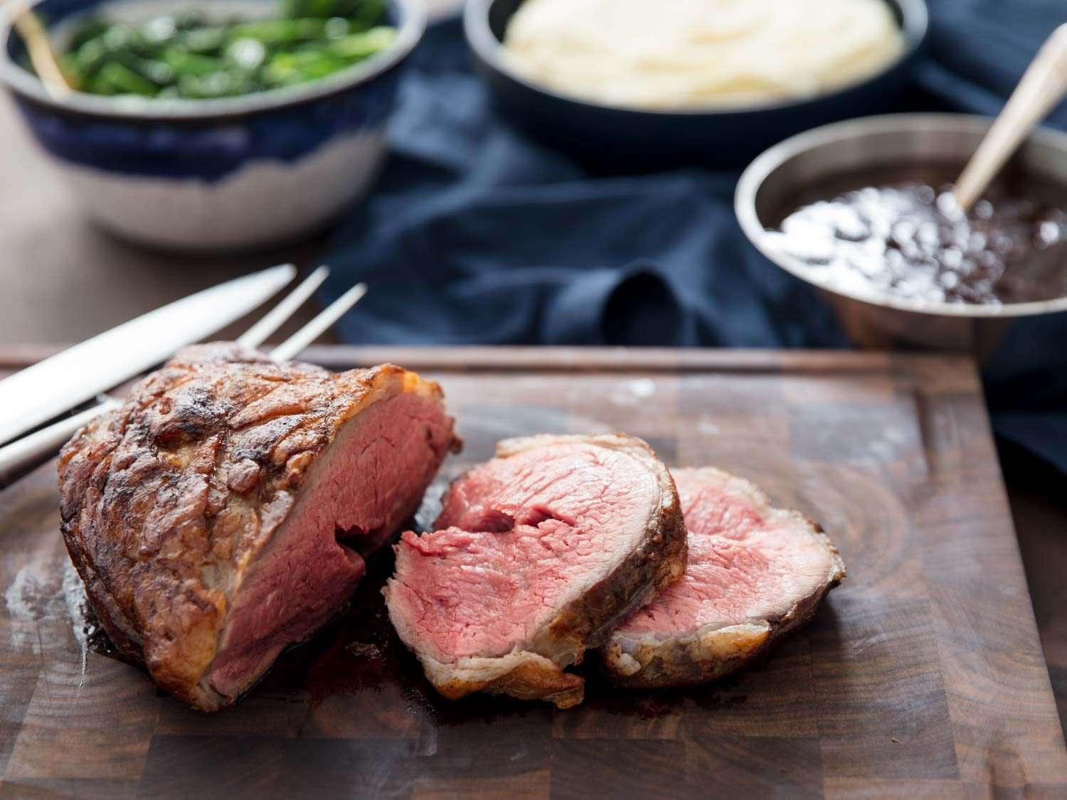 Side view of tri-tip roast sliced on cutting board.