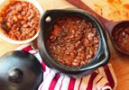 Overhead view of a black la chamba clay pot full of barbecue beans.