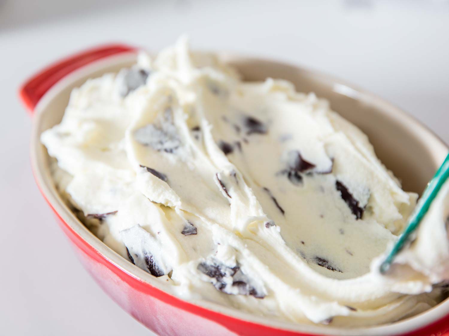 An oval baking dish full of stracciatella gelato.
