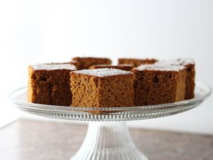 Squares of Gluten-Free Pumpkin Gingerbread on a glass cake stand