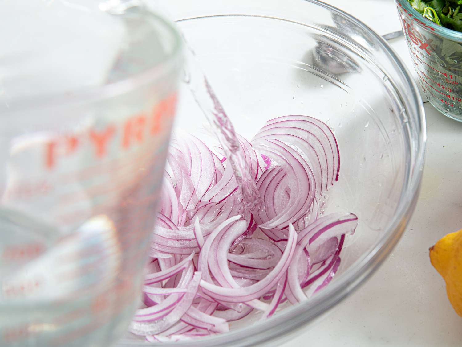 Overhead view of adding water to onions