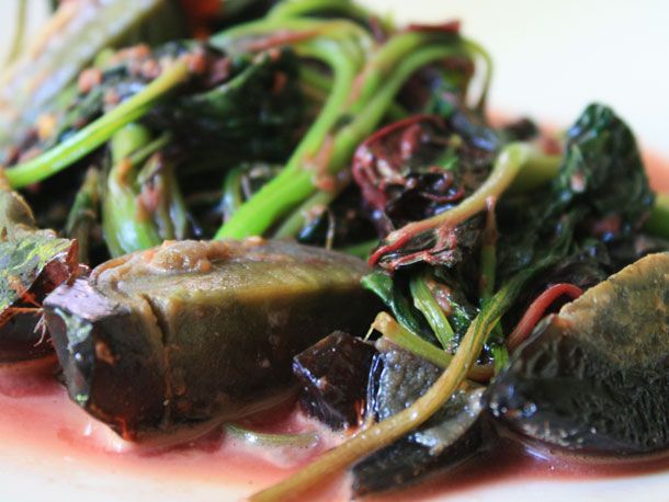 Boiled greens with a preserved duck egg. 