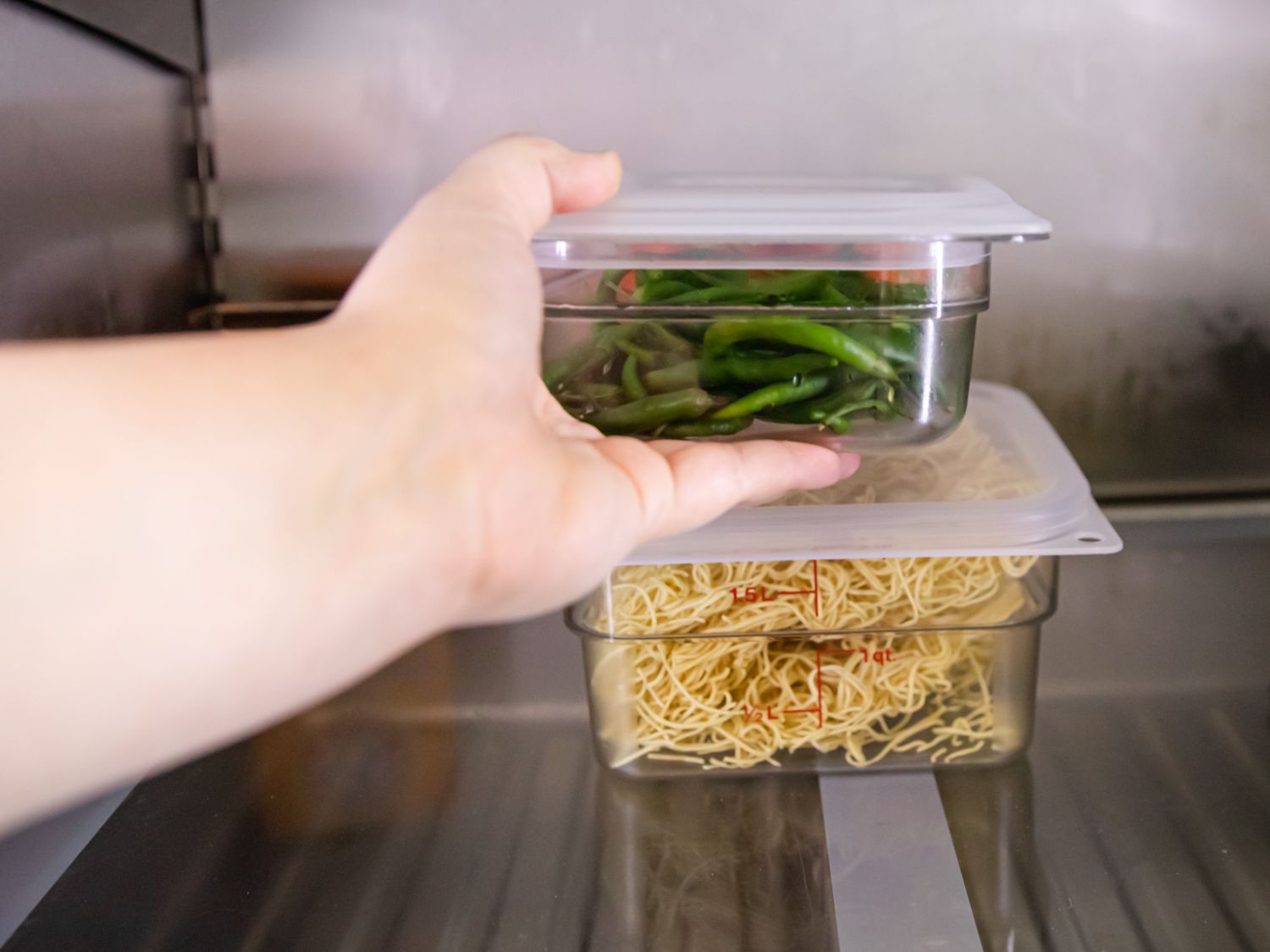 two containers stacked on top of one another in the fridge