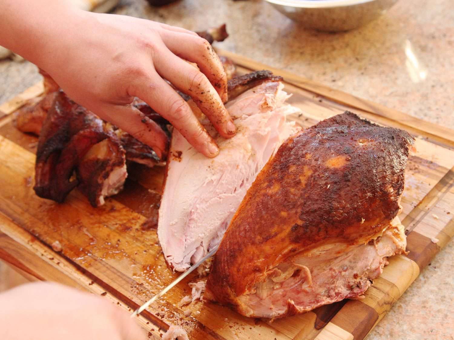 Carving smoked turkey breast.