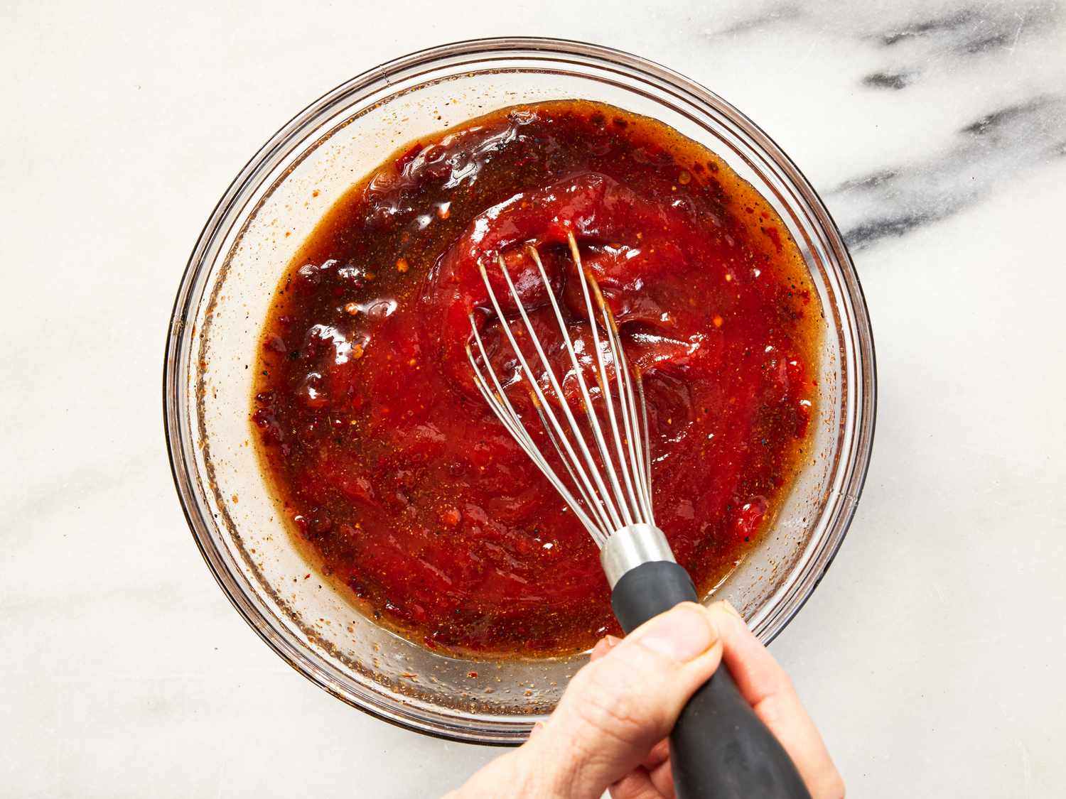 Overhead view of whisking bbq sauce