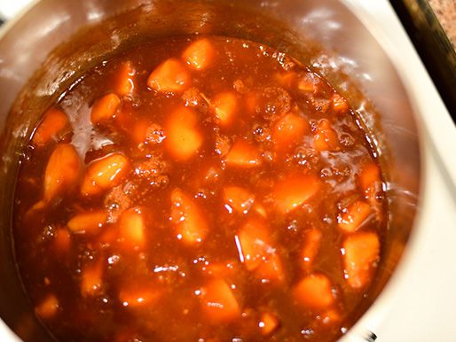 Peaches, ketchup, and the rest of the ingredients are added to the pot.
