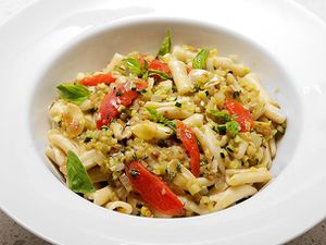 Summer ratatouille with pasta, served in a white porcelain bowl.
