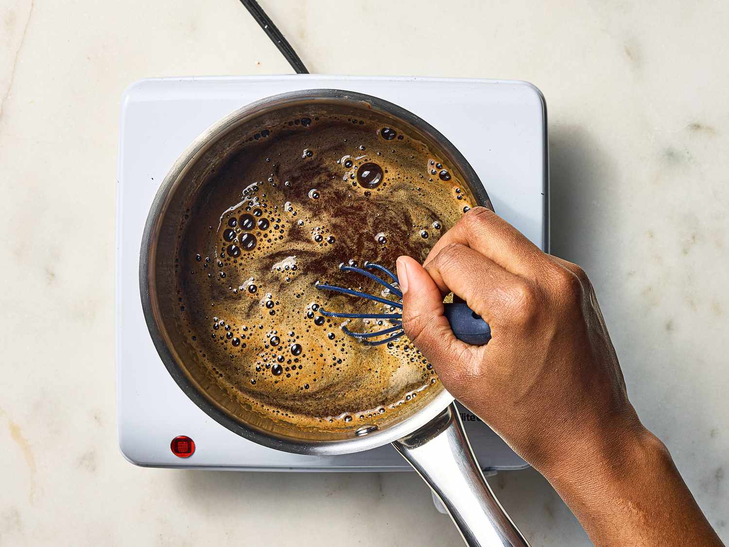 whisking beer, sugar and espresso in a small saucepan