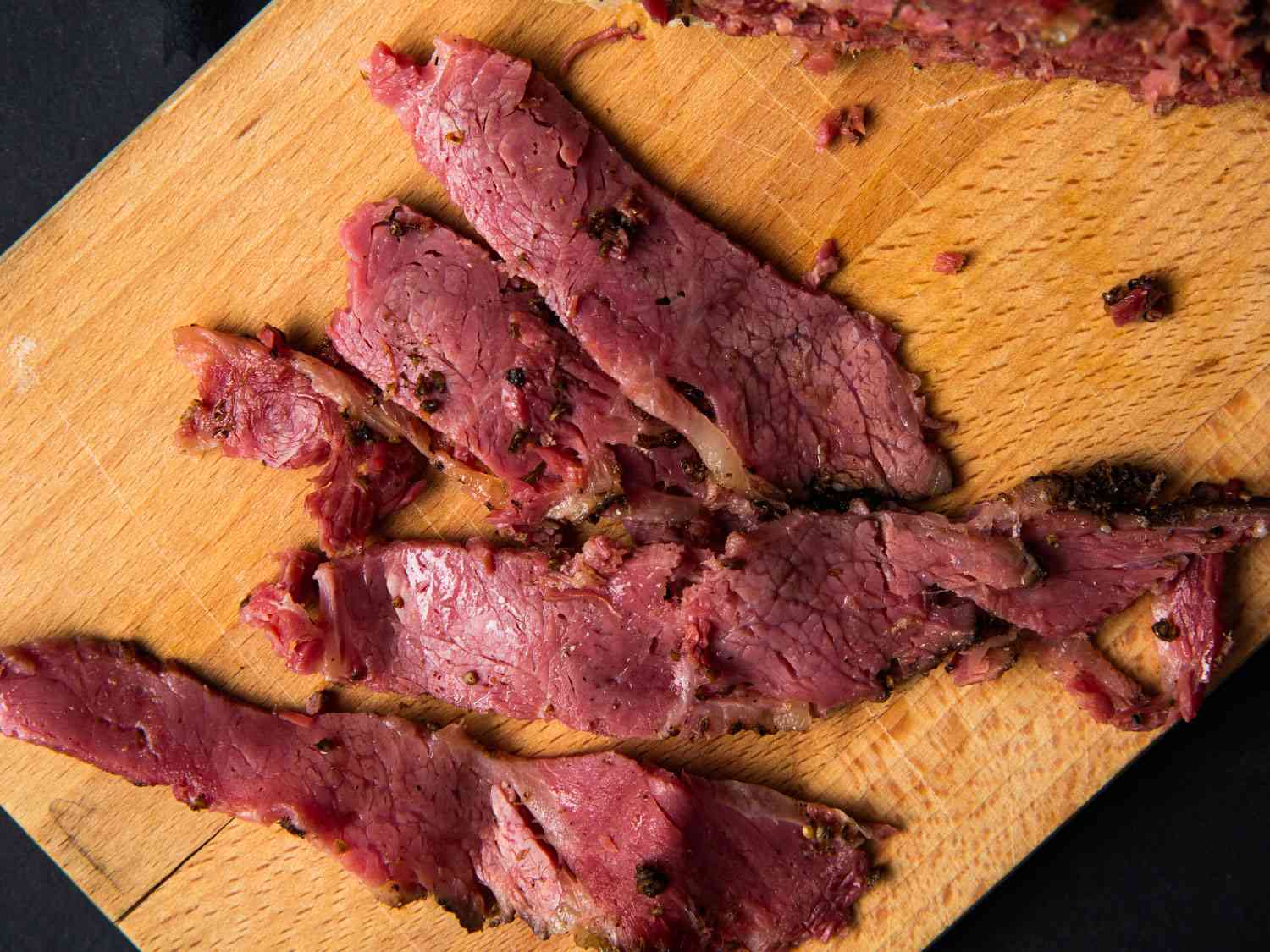 Pieces of pastrami on a cutting board