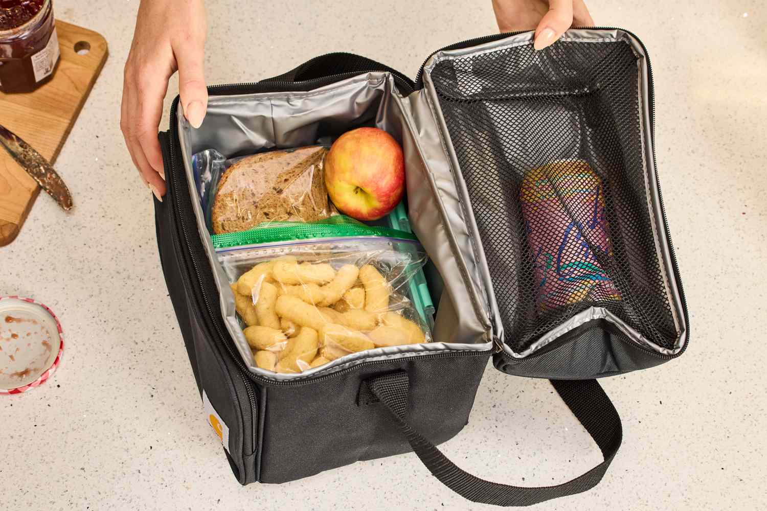 The inside of a black Carhartt lunch box