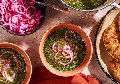 Molokhia soup in a bowl with pickled red onions.