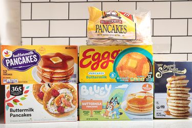 Five different brands of frozen pancakes displayed against a tile background including 365 Eggo and Buttermilk Pancakes packaging