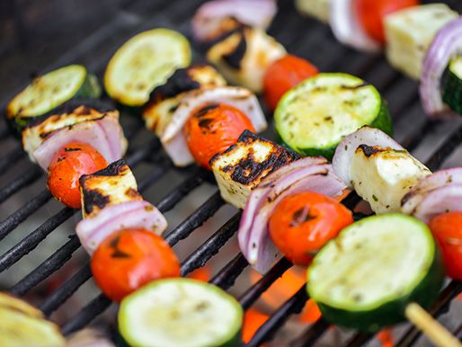 A close up of grilled skewers with vegetables and halloumi with a little char.