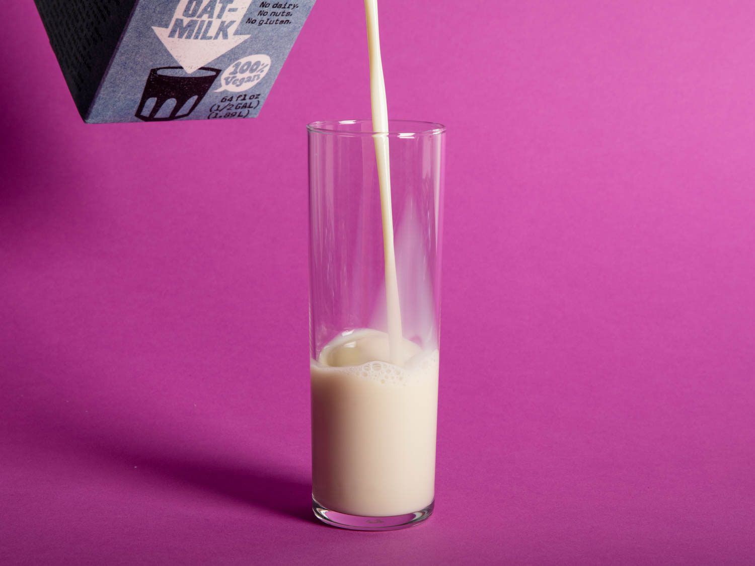 Pouring oat milk into glass.