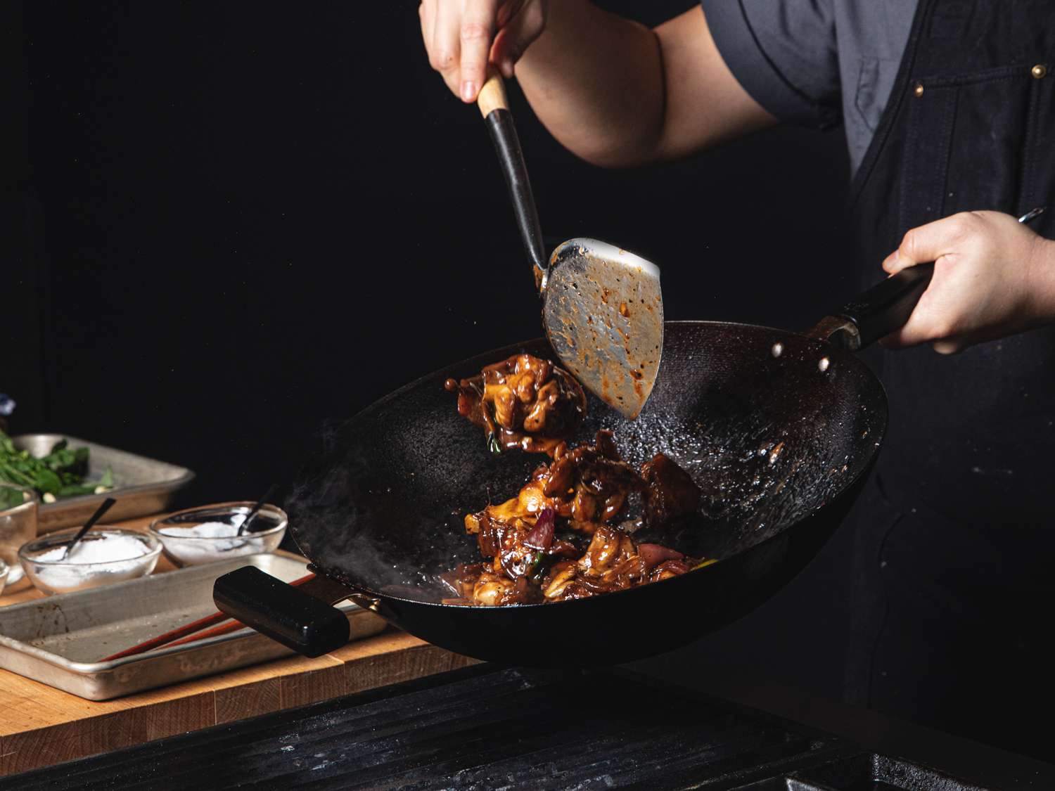 Braised pork being tossed in a wok.