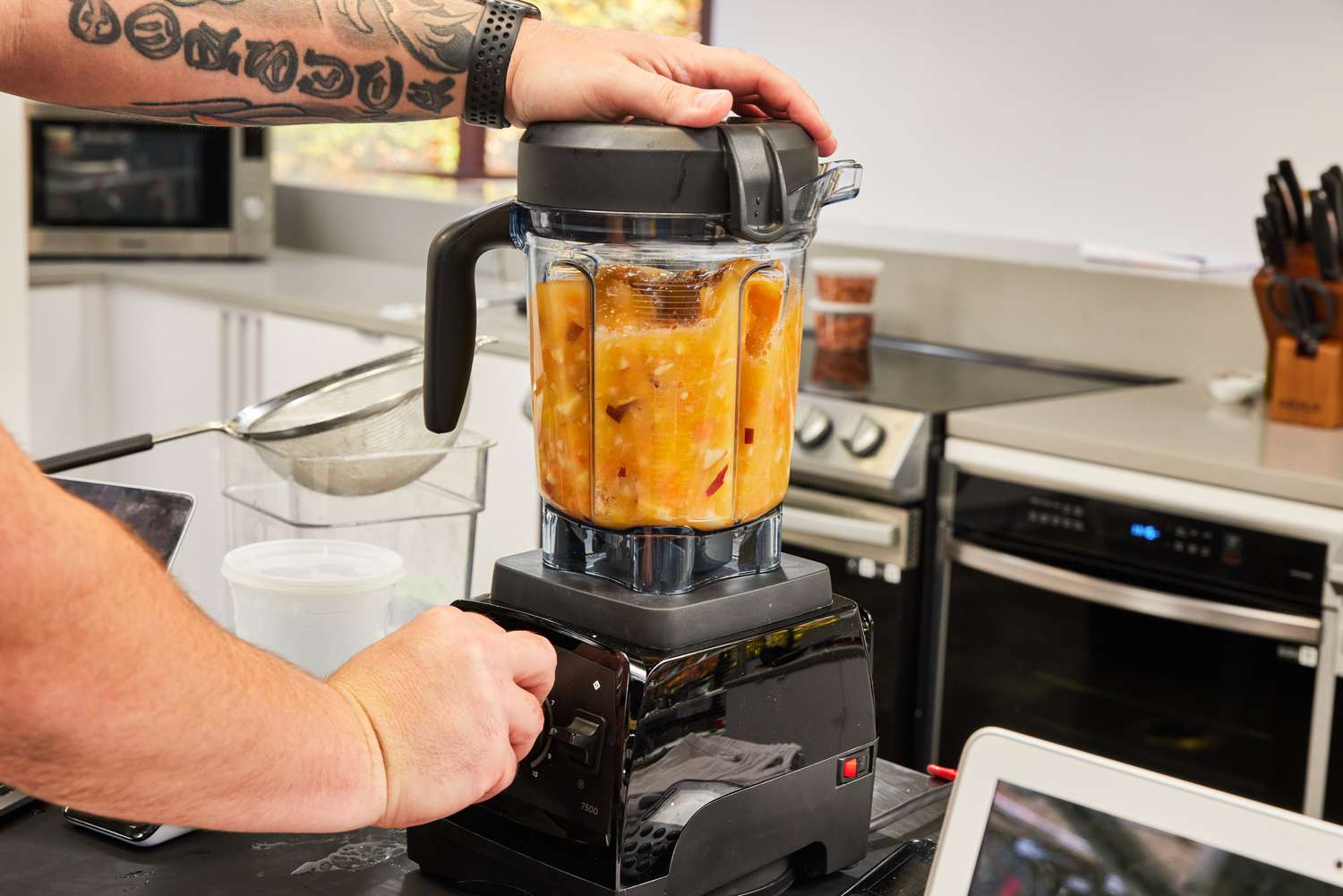 Hand turning the dial on the Vitamix 7500 Blender to blend food