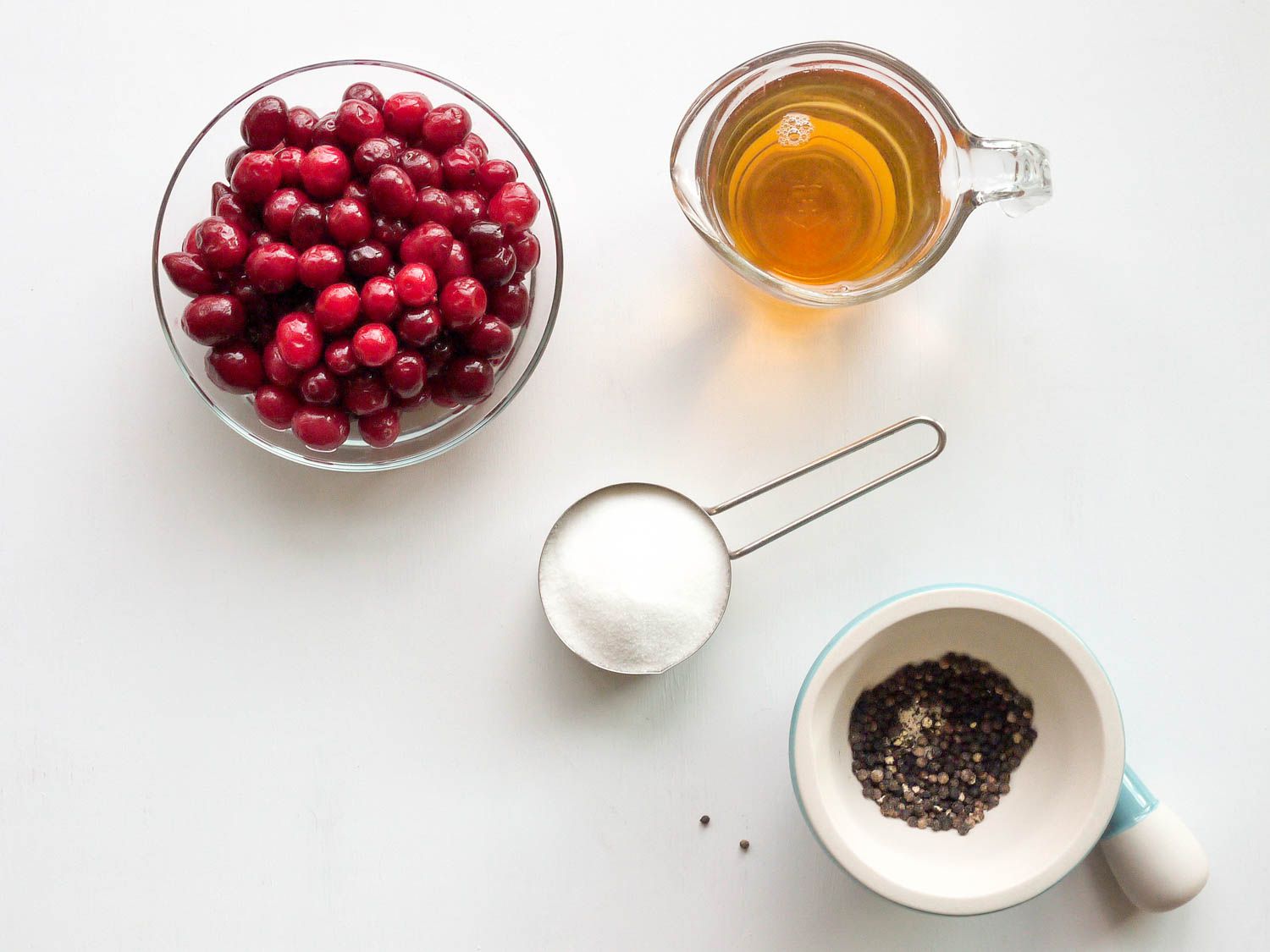 Ingredients for cranberry–black pepper shrub on the table. 
